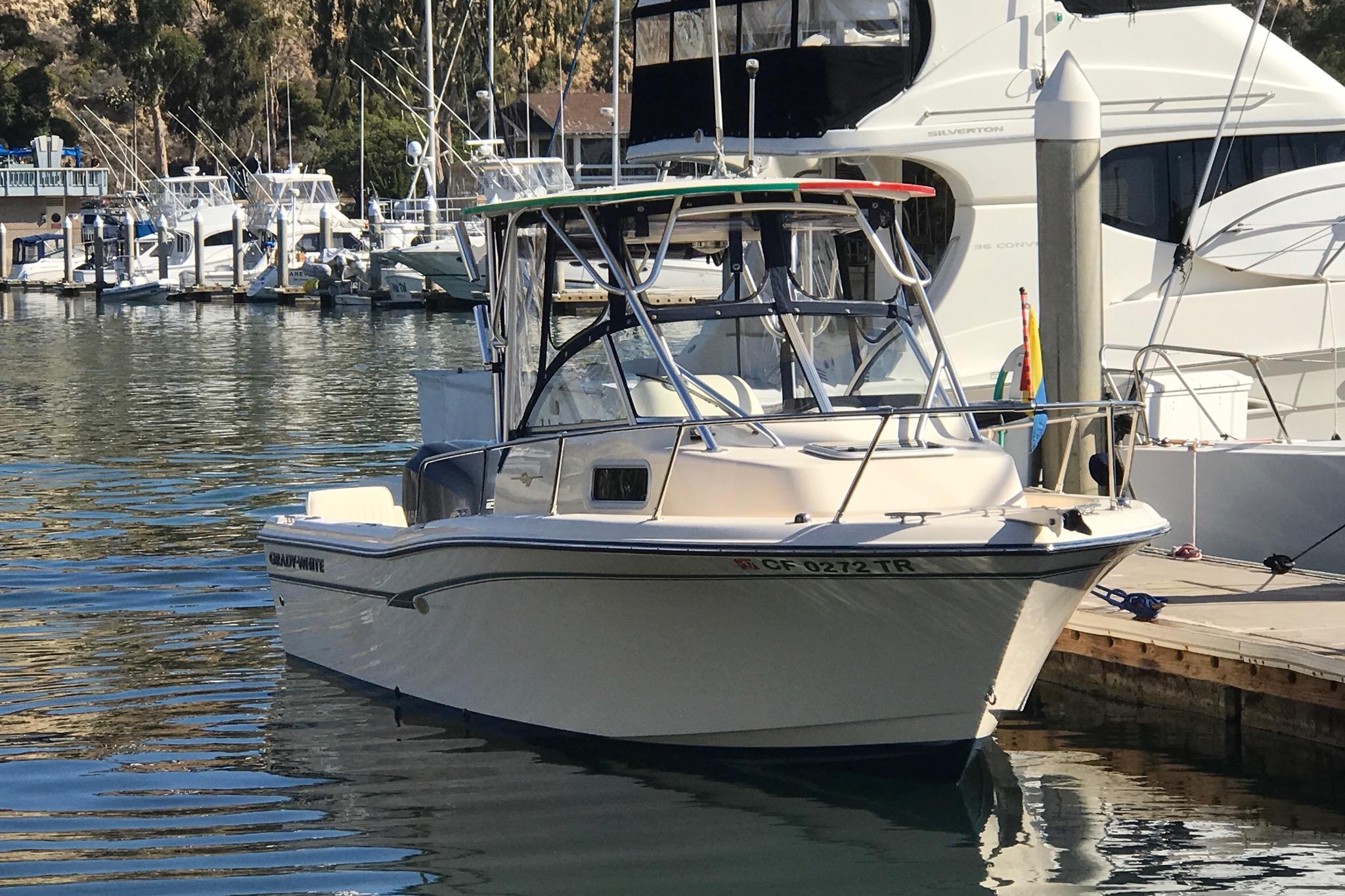 2012 Grady-White Adventure 208 boat docked in a marina.