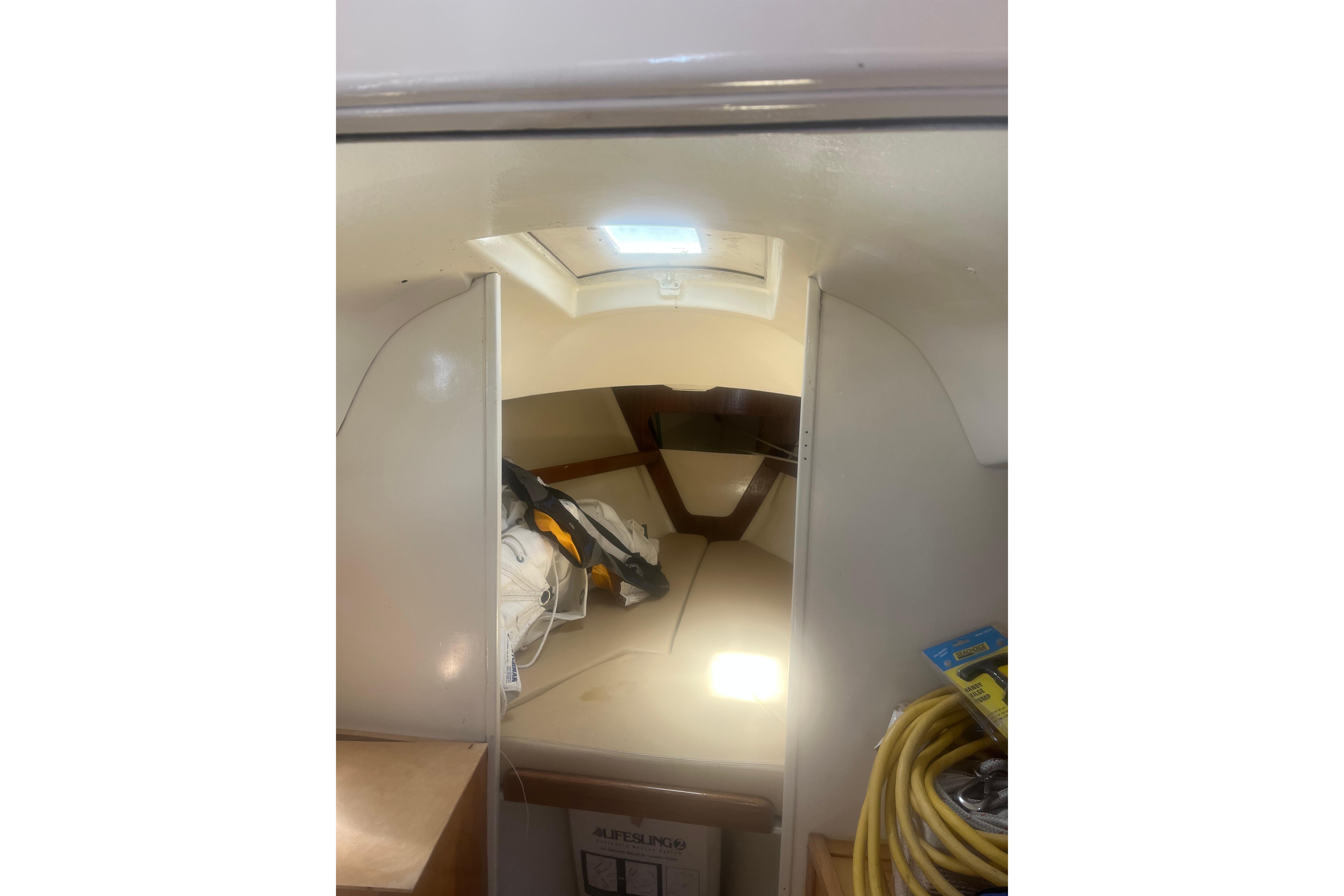 Interior cabin of a 1972 C&C 30 sailboat with storage and seating area.