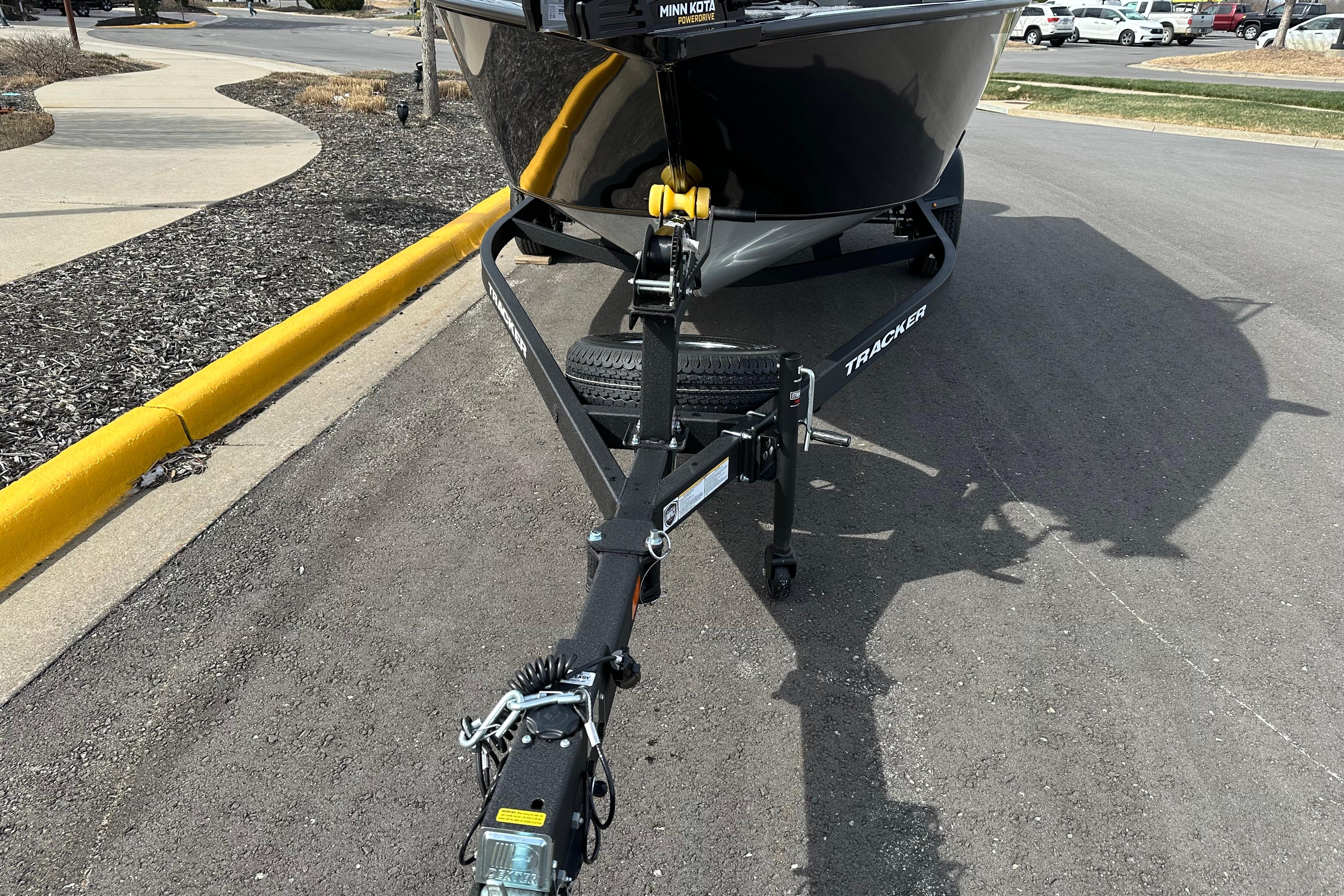 2026 Tracker Pro Guide V-175 Combo boat on trailer, parked on asphalt road.