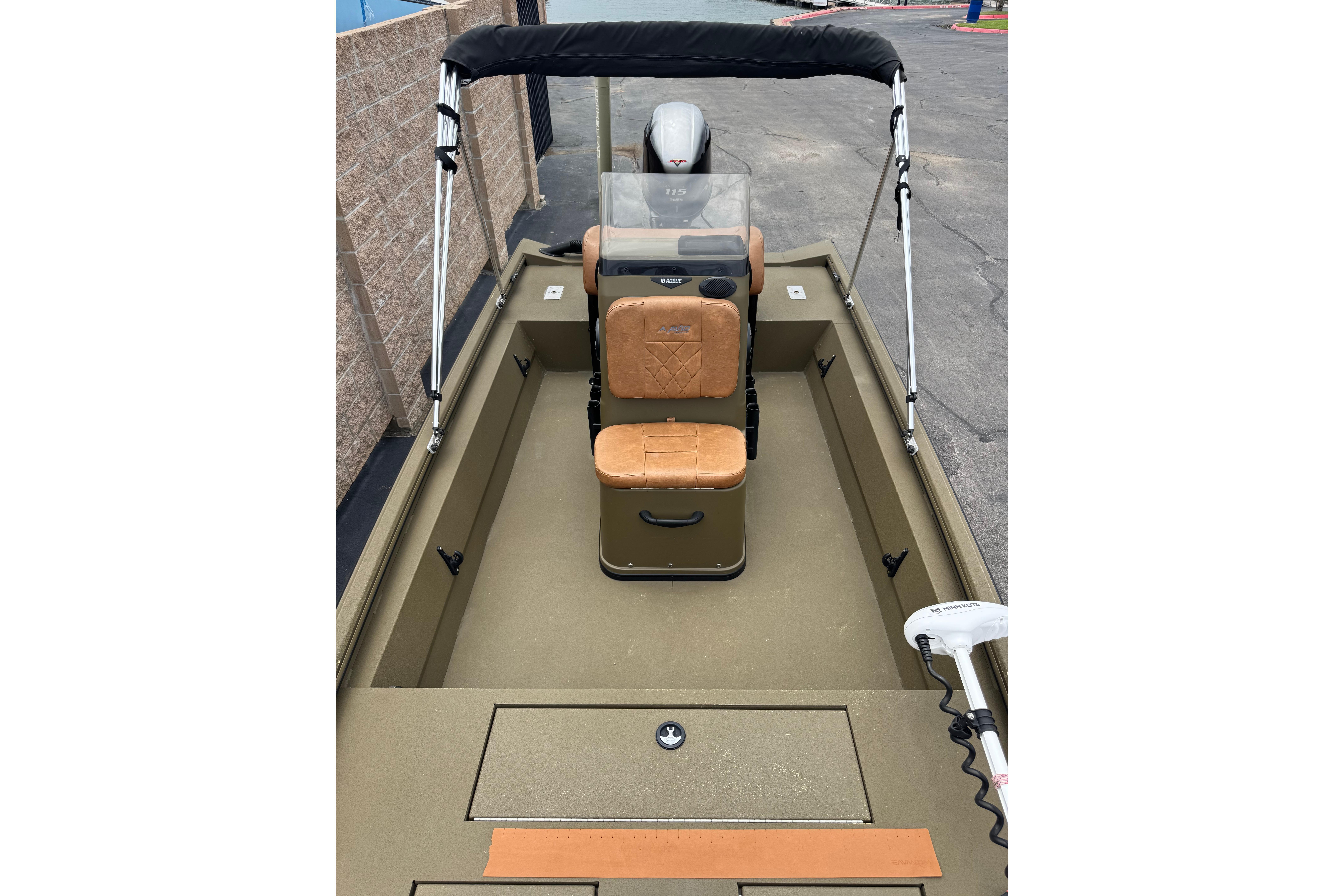 2023 Avid 18 Rogue CC boat interior with tan seating and steering console.
