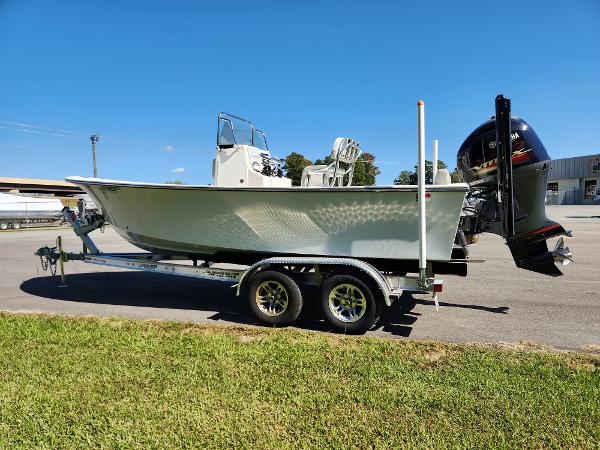 2023 May-Craft 208 CC boat on trailer, parked outdoors under clear blue sky.