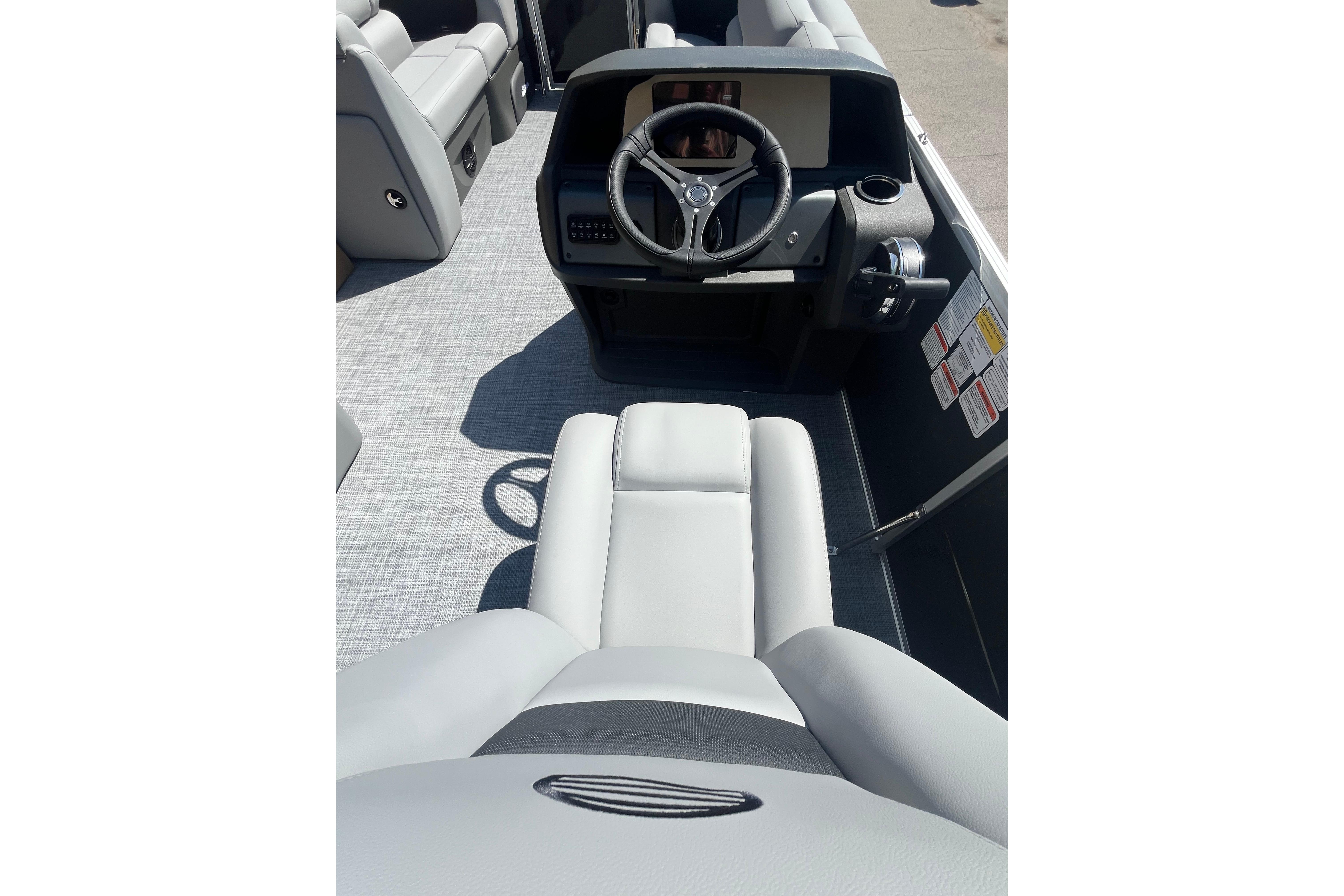 2026 Sun Tracker Party Barge 20 DLX interior with steering wheel and seating.