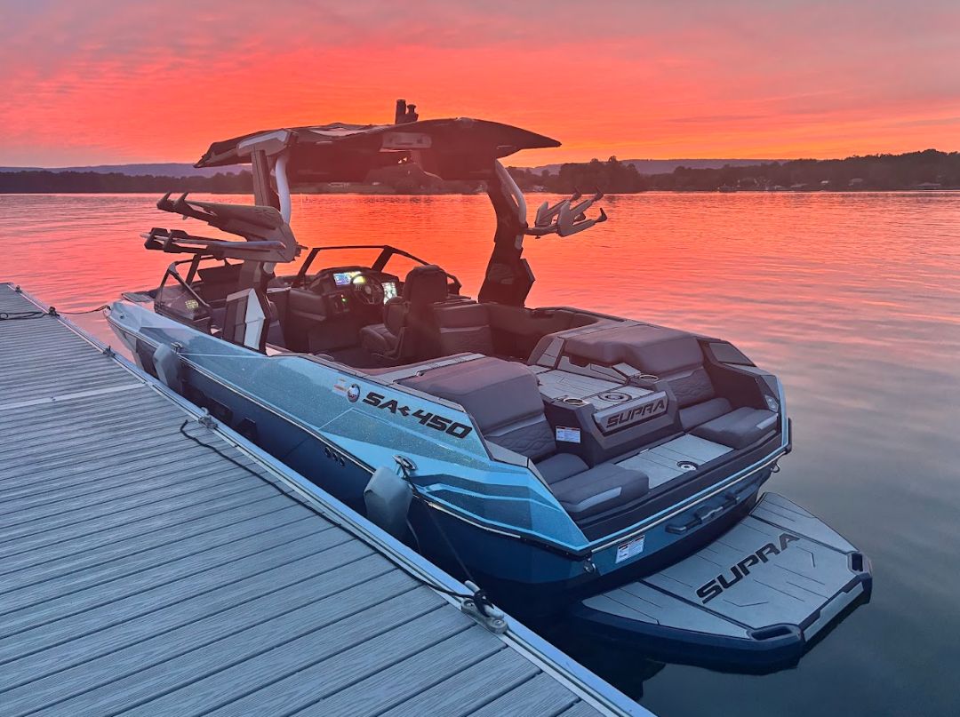 2025 Supra SA 450 boat docked at sunset.