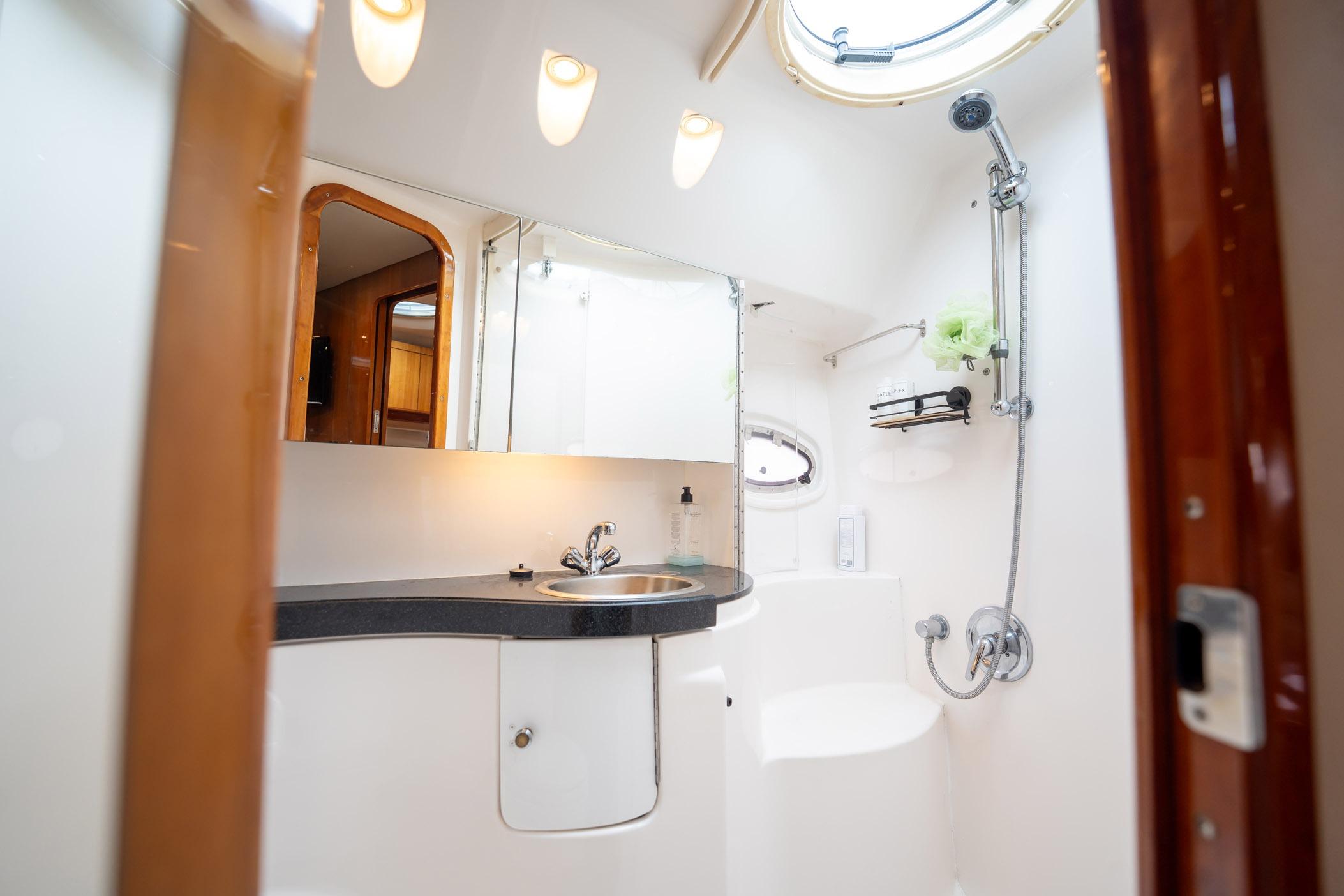 Luxurious bathroom interior of 2008 Regal Commodore 4460 yacht with modern fixtures.