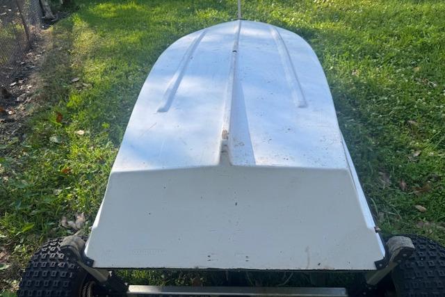 1999 Beacon Boats Pram upside down on grass, showcasing hull design.