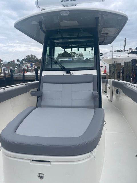 2023 Boston Whaler 330 Outrage with gray seating outdoors.