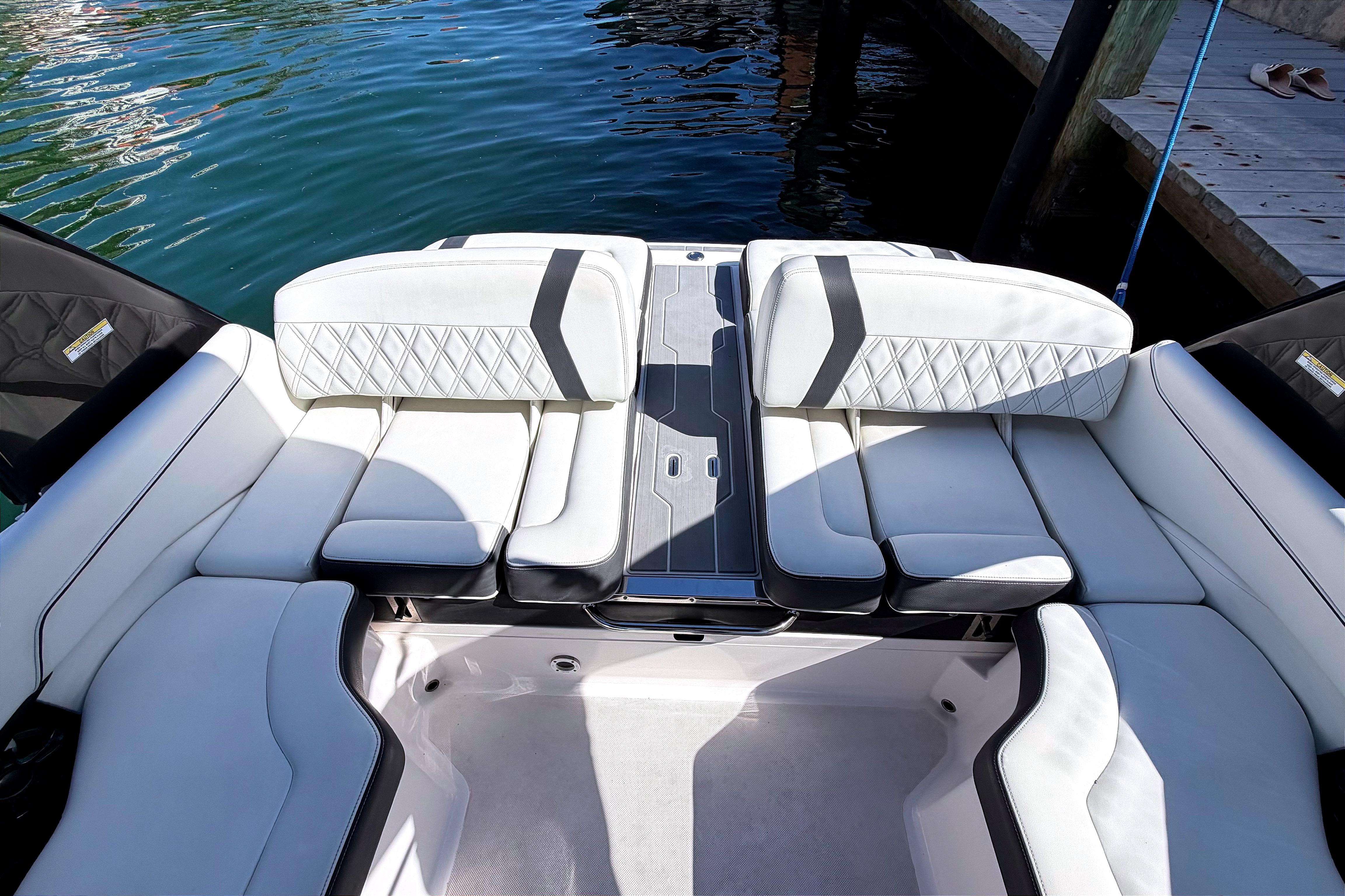 2020 Regal 2300 Bowrider interior with white cushioned seating by the water.