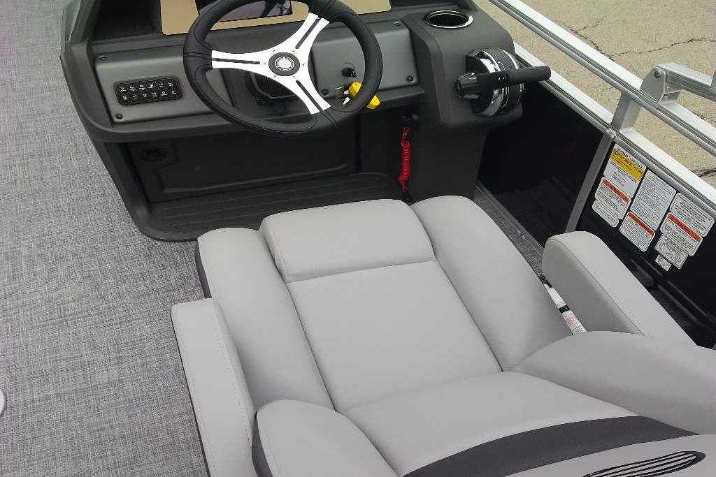 2026 Sun Tracker SportFish 20 DLX boat interior with steering wheel and comfortable seating.