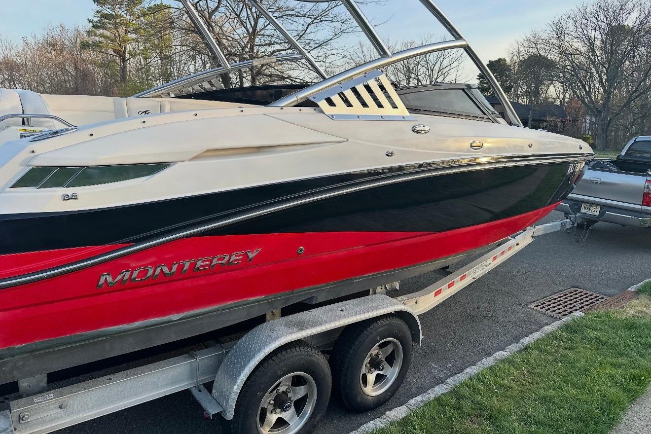 2012 Monterey M5 MSX Sport Boat on trailer, red and black design.