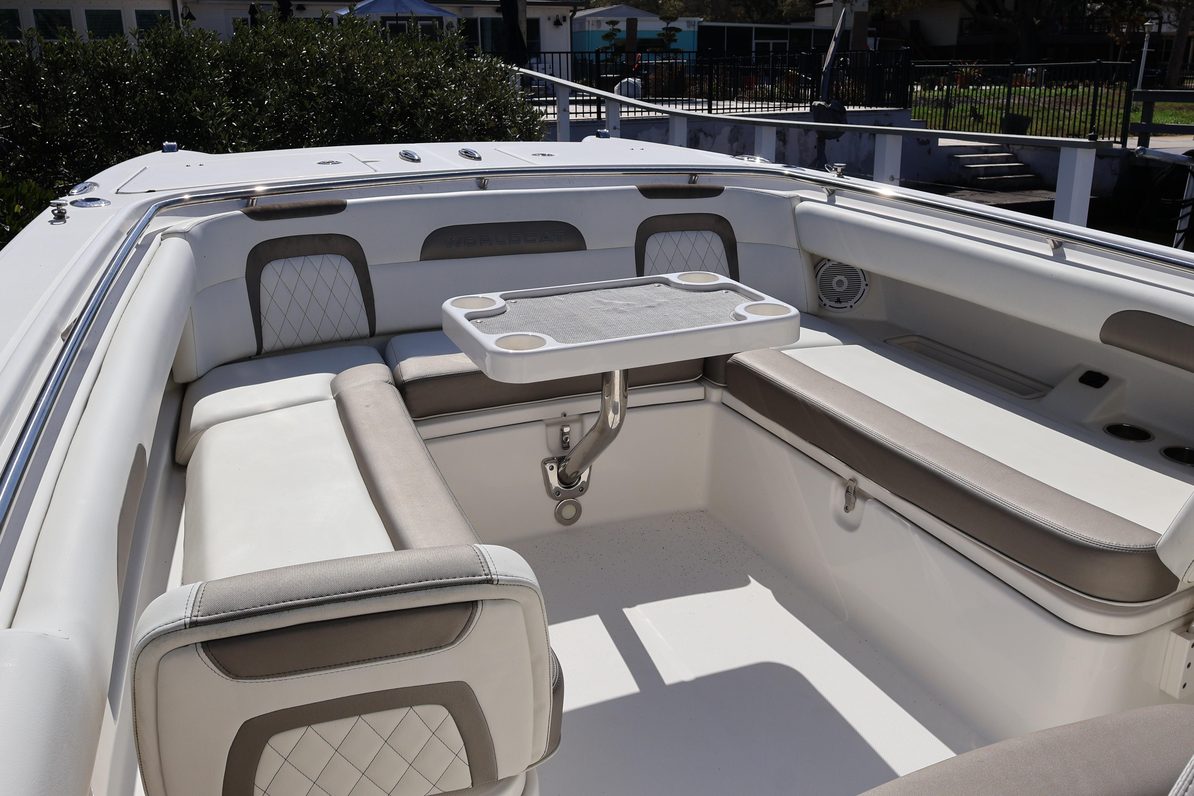2022 World Cat 280 CC-X boat interior with cushioned seating and table.