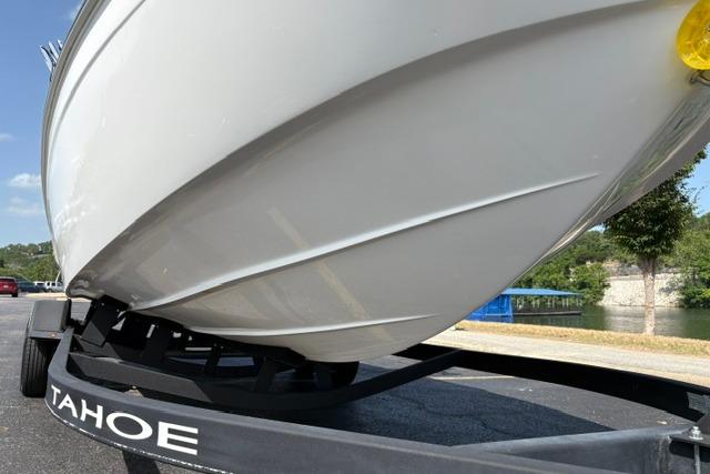 2024 Tahoe T21 boat on trailer, showcasing sleek hull design and branding.