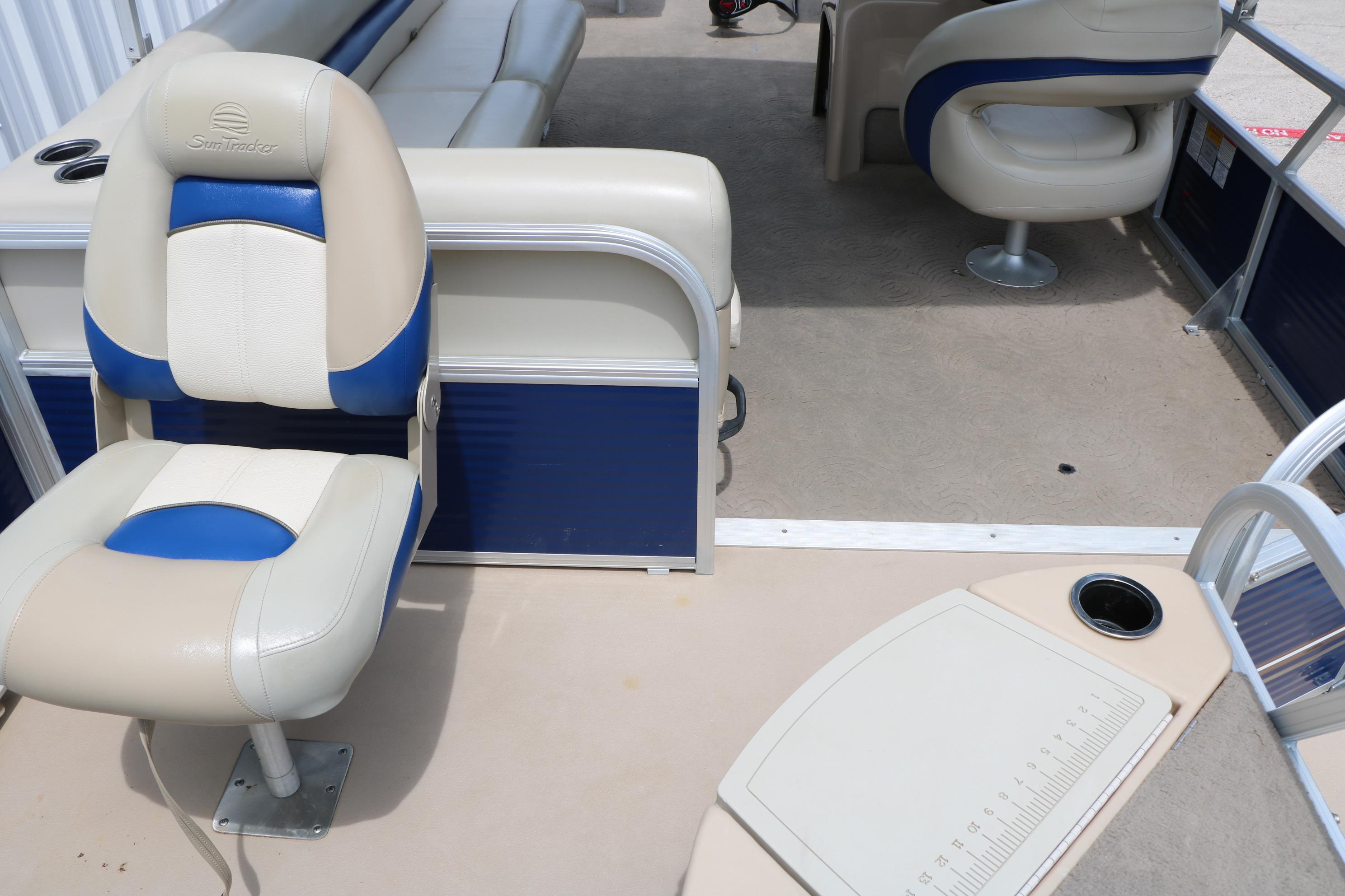2013 Sun Tracker Fishin' Barge 20 DLX interior with seating and fishing station.