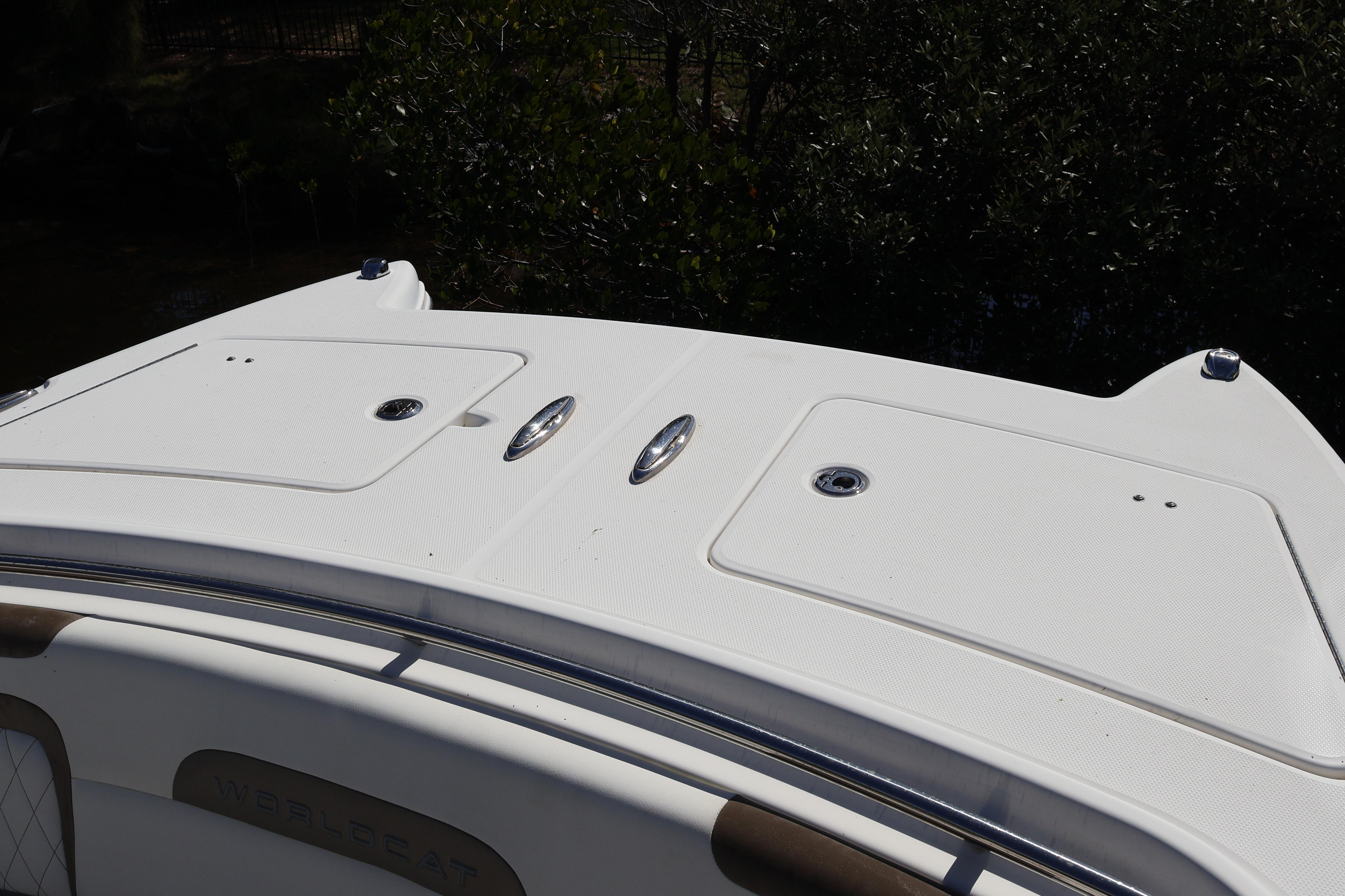 2022 World Cat 280 CC-X boat deck with storage compartments and sleek design.
