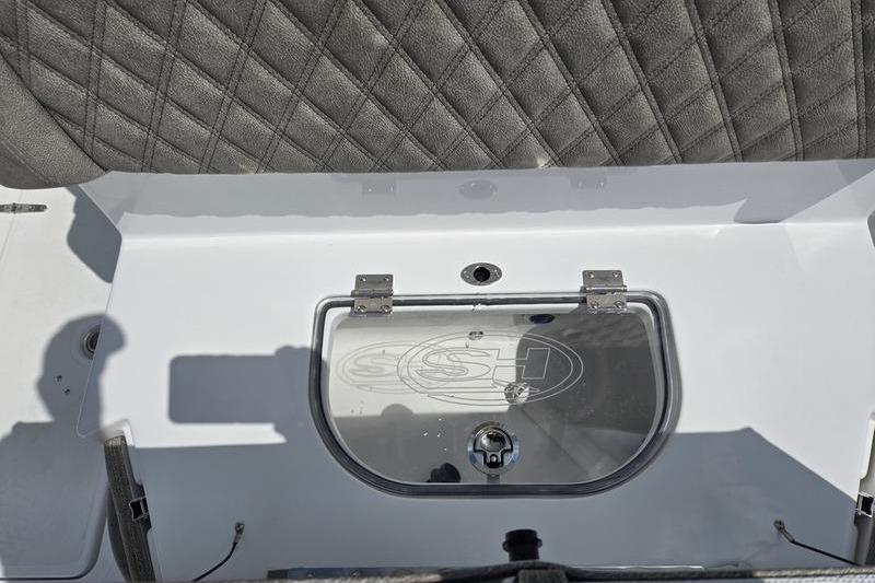 2027 Sea Hunt Ultra 275 SE boat interior with cushioned seating and storage compartment.