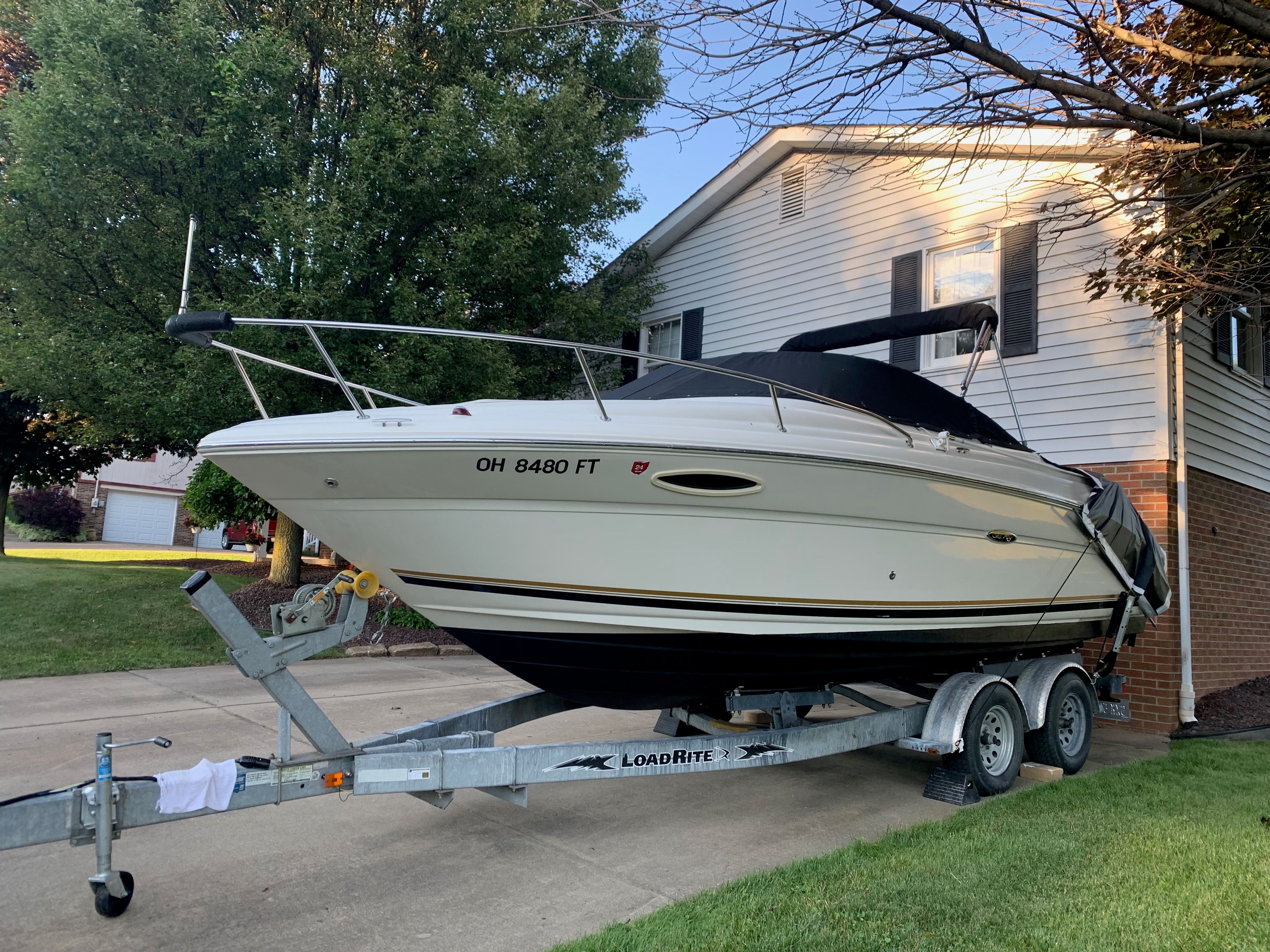 2006 Sea Ray 215 Weekender on trailer in front of house.