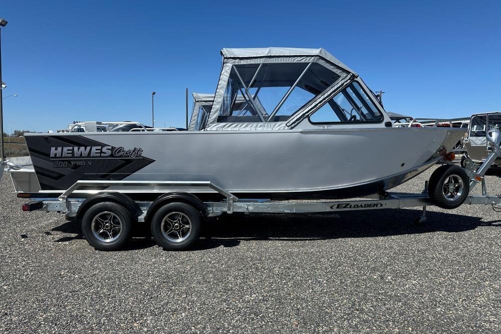 2026 Hewescraft 200 ProV ET boat on trailer under clear blue sky.
