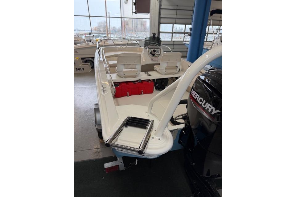 2026 Boston Whaler 160 Super Sport boat with Mercury engine in showroom.