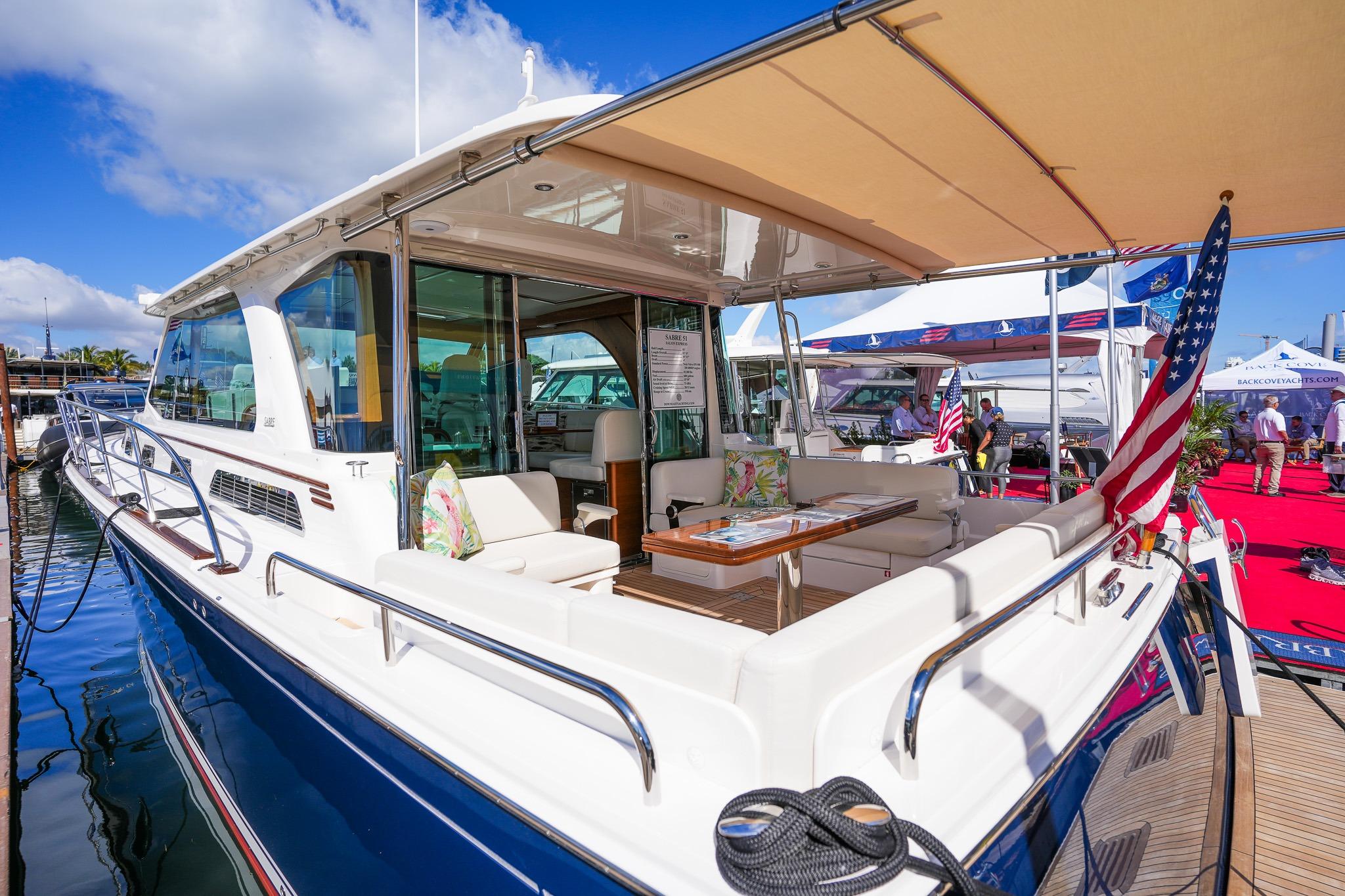 2026 Sabre 51 Salon Express luxury yacht docked at marina, showcasing elegant design.