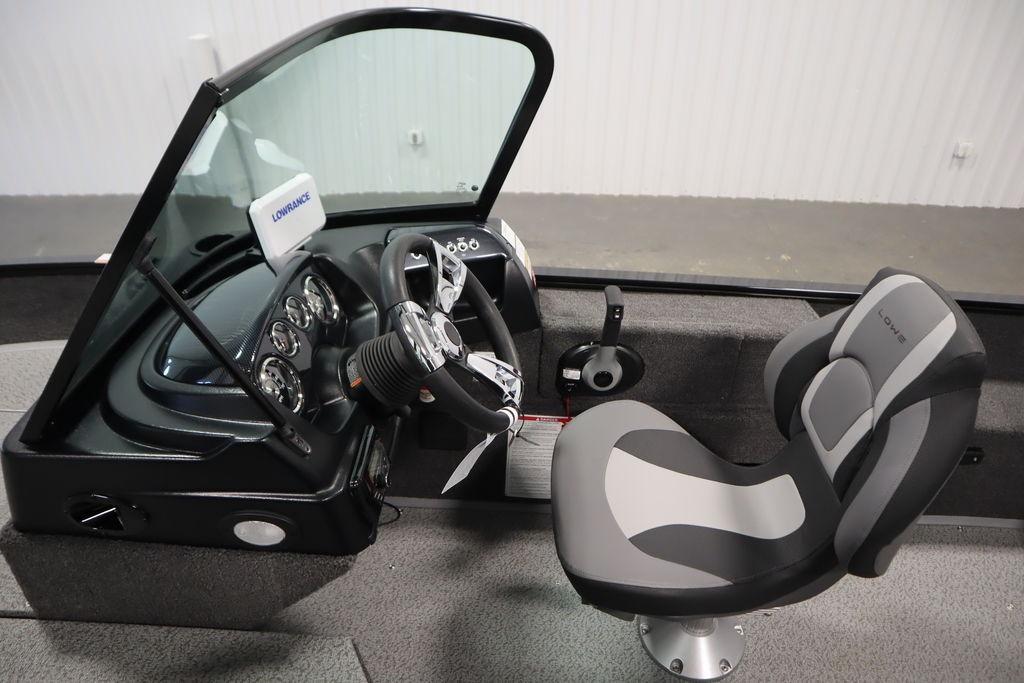 2026 Lowe Fishing Machine 175 cockpit with steering wheel and comfortable seat.
