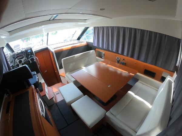 2017 Jeanneau NC 11 interior with dining area and helm station.