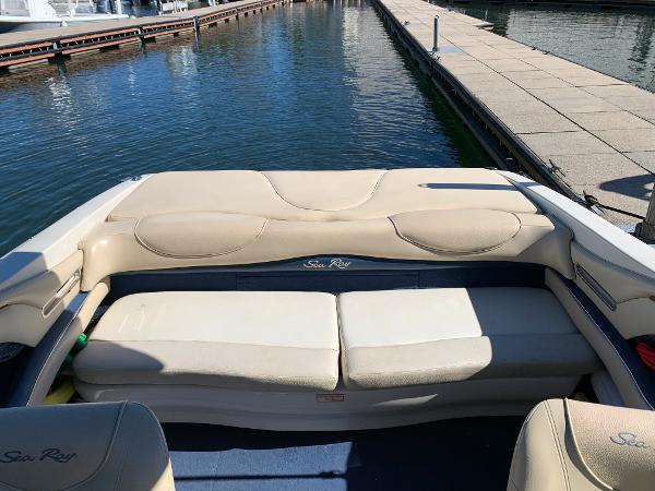 2000 Sea Ray 210 Bow Rider boat interior with beige seating at a marina.