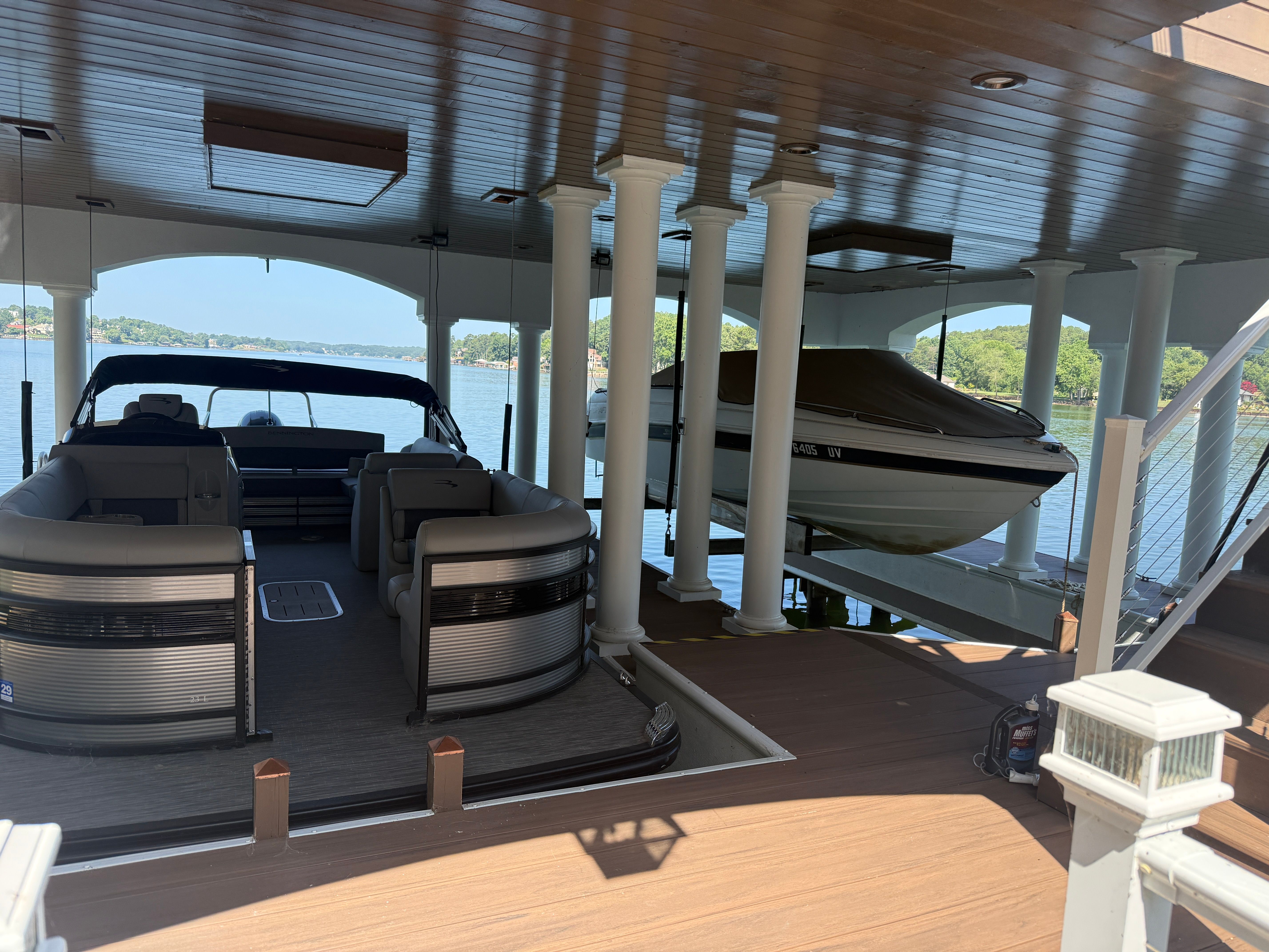 A 2000 Starcraft Next Star 19 is docked in a covered boathouse by the water.