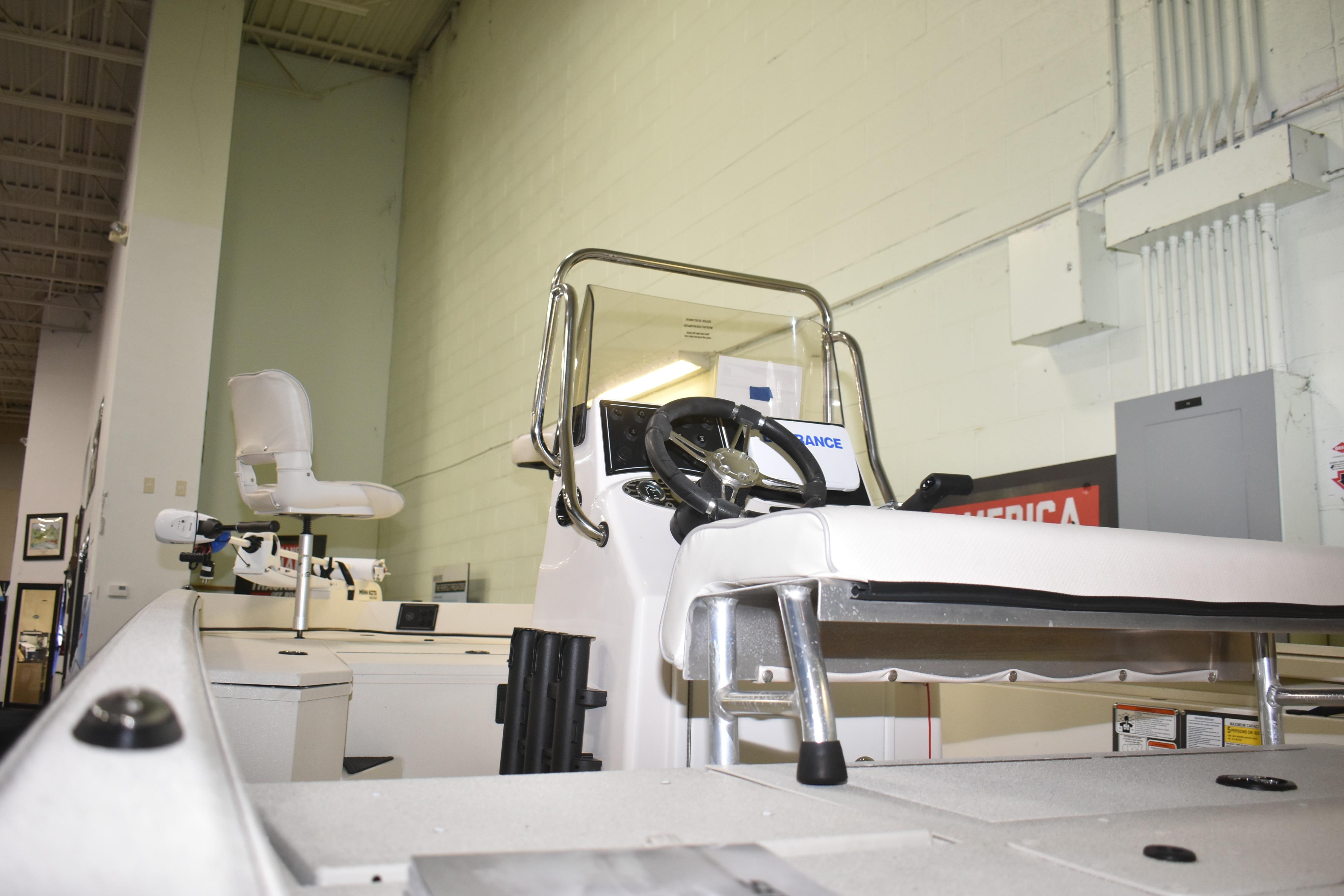 2024 Ranger RB200 boat interior with steering wheel and seating in showroom.