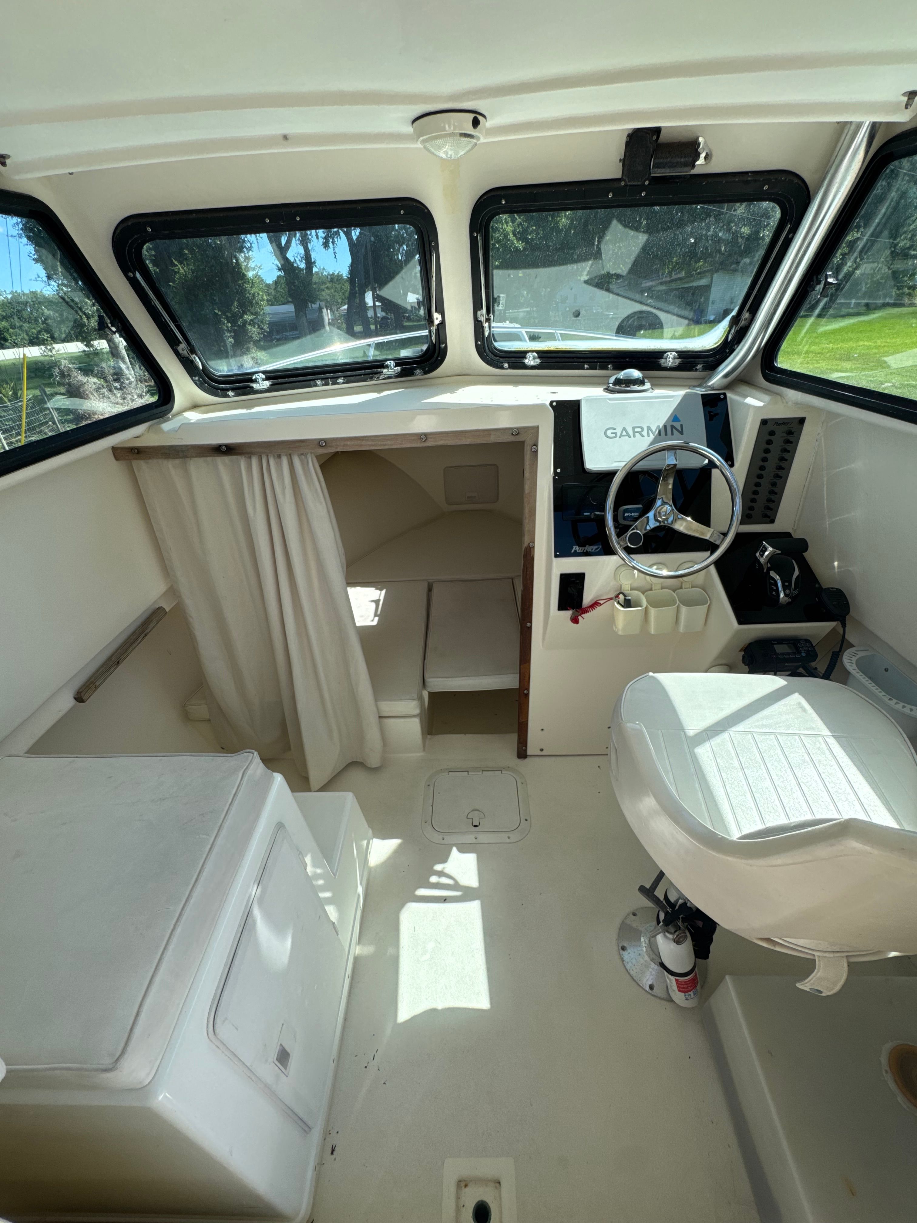 Interior of a 1997 Parker 2520 boat with helm and seating.