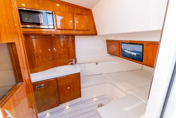 Luxurious interior of 2020 HCB 53 Sueños yacht with wood cabinetry and seating.