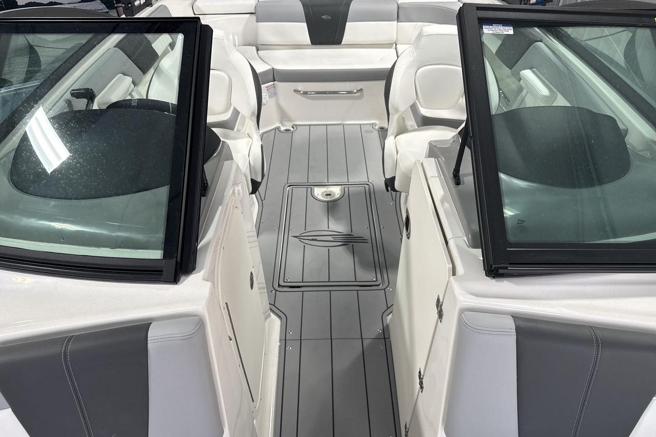 The image shows the cockpit of a Chaparral 23 SSi boat with gray flooring.