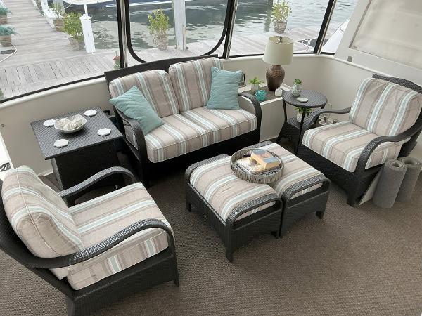Cozy seating area on 2000 Novatec Islander 55 yacht with striped cushions and waterfront view.