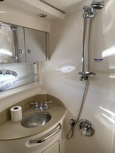 2004 Chaparral Signature 350 bathroom with sink, shower, and storage cabinets.