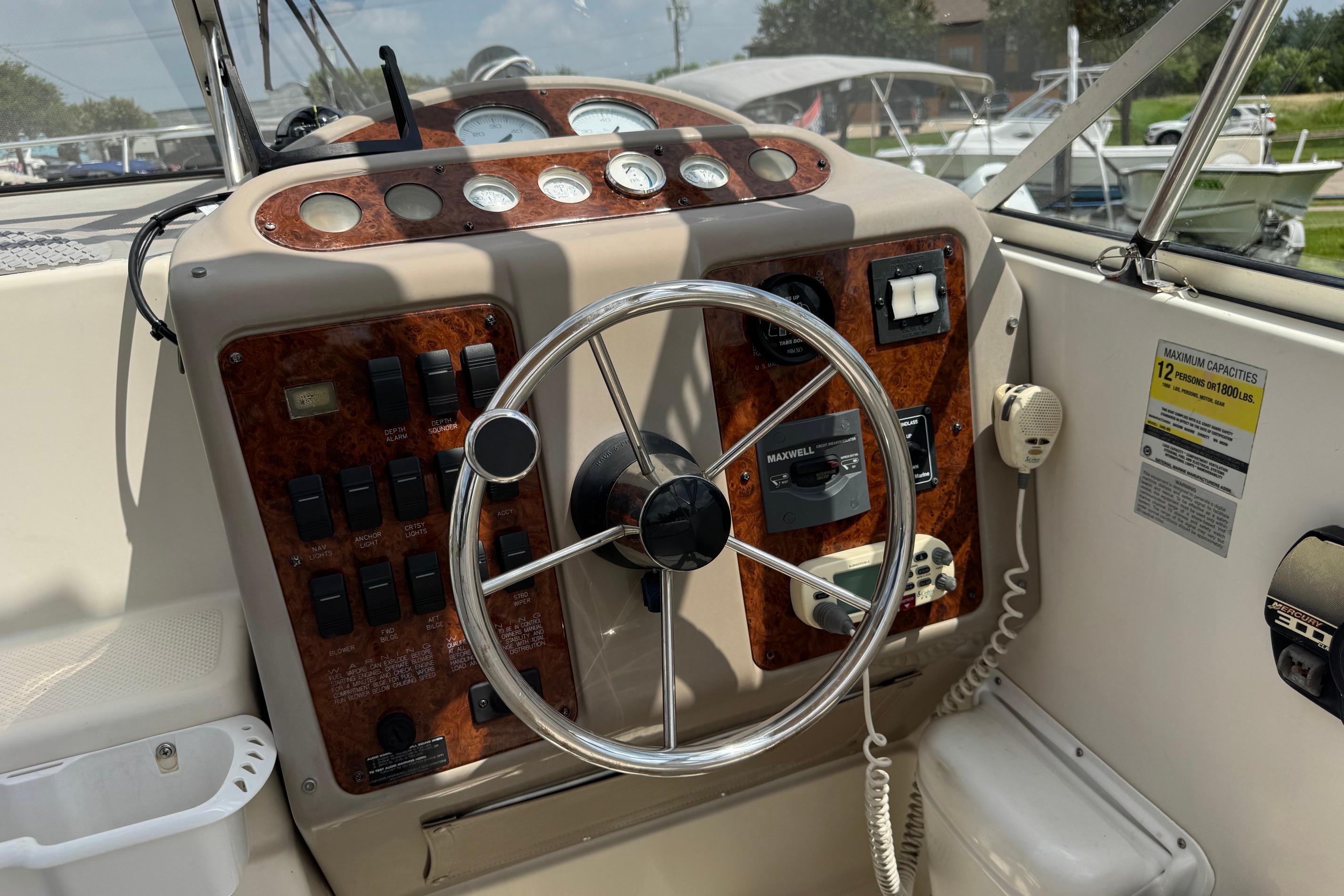 Steering console of a 2000 Maxum 2400 SCR boat with gauges and controls.