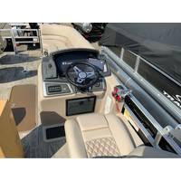2025 Ranger Reata 223FC boat interior with steering wheel and beige seating.