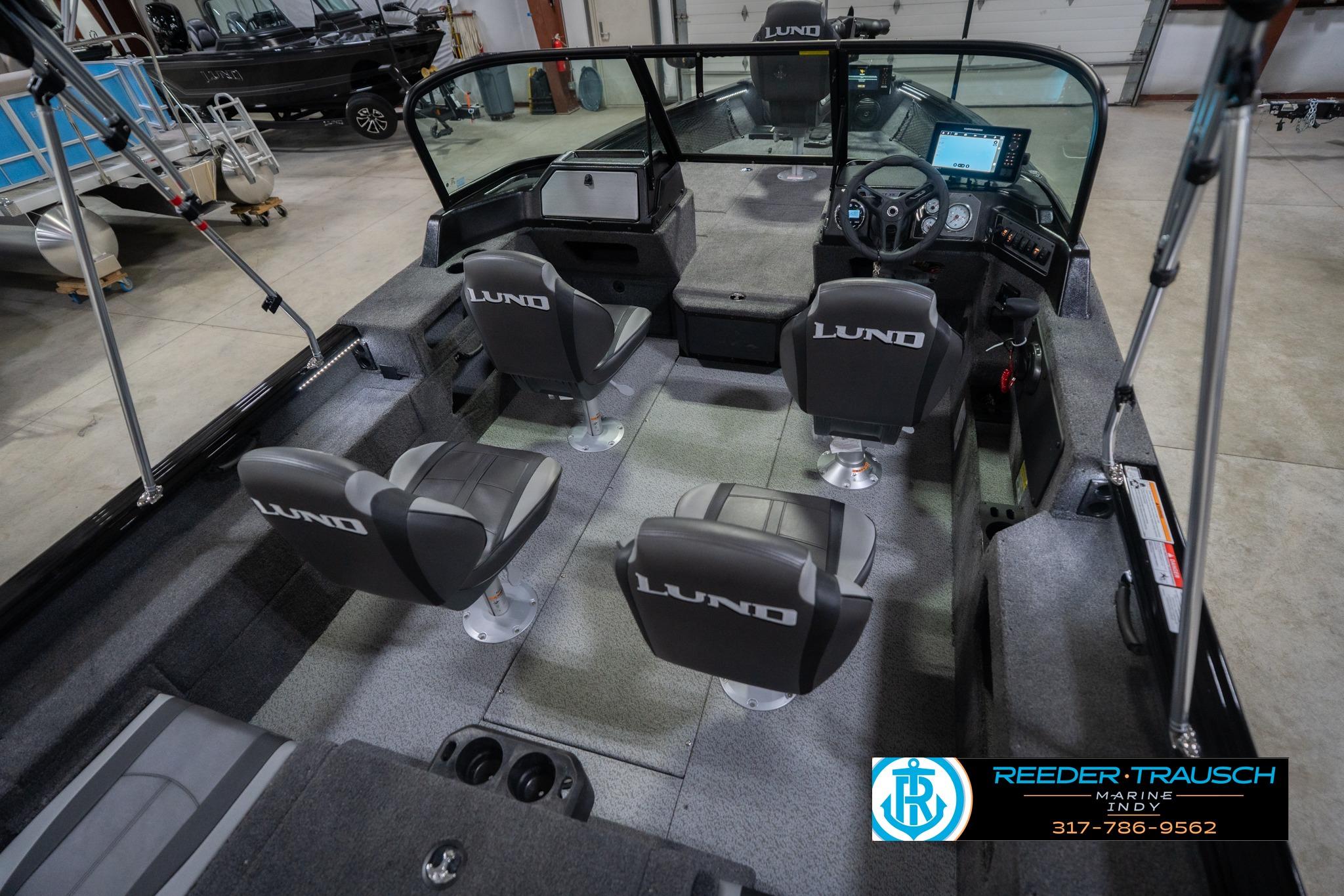 2026 Lund 2075 Impact XS boat interior with four seats and steering console.