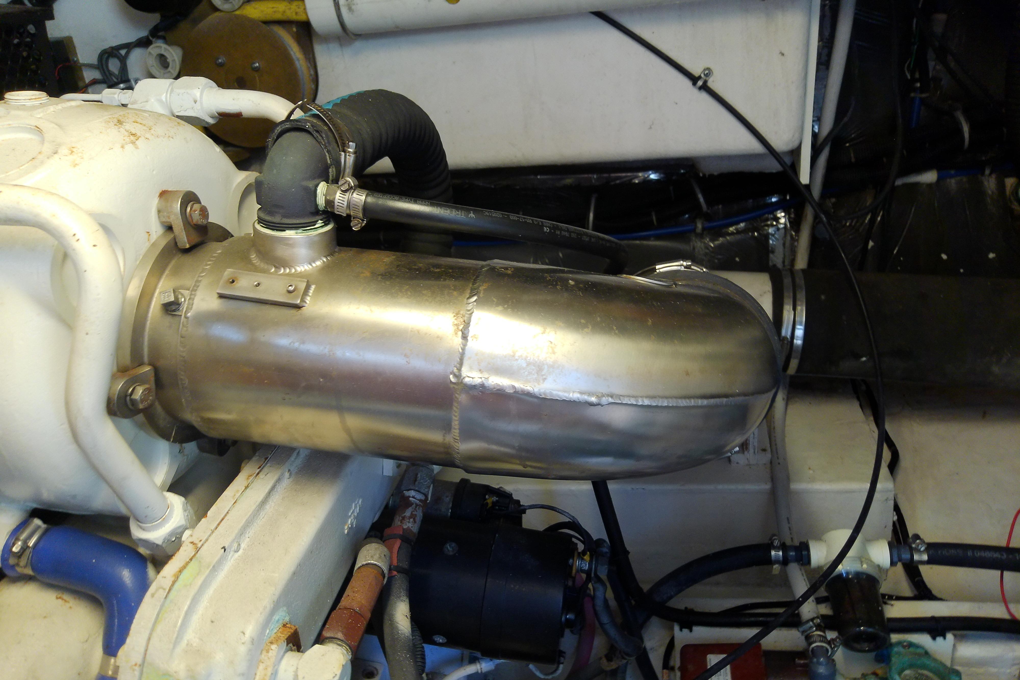 Engine compartment of a 2000 Tiara Yachts 4100 Open, featuring metal exhaust components.