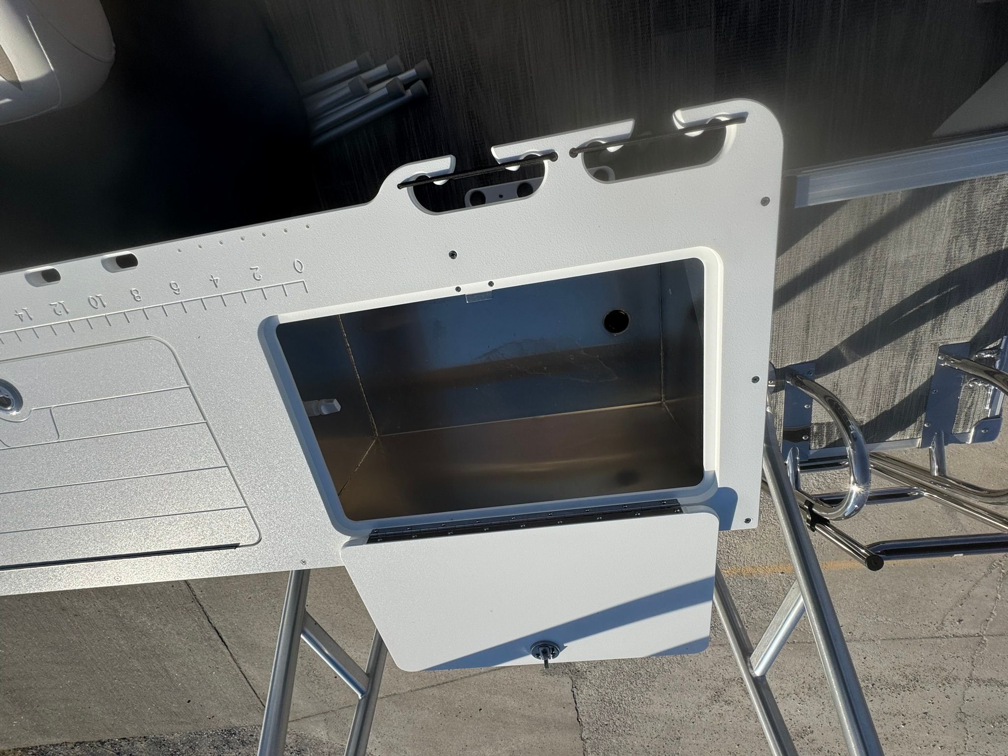 Landau 23C Atlantis 2026 boat feature with storage compartment and measuring scale.