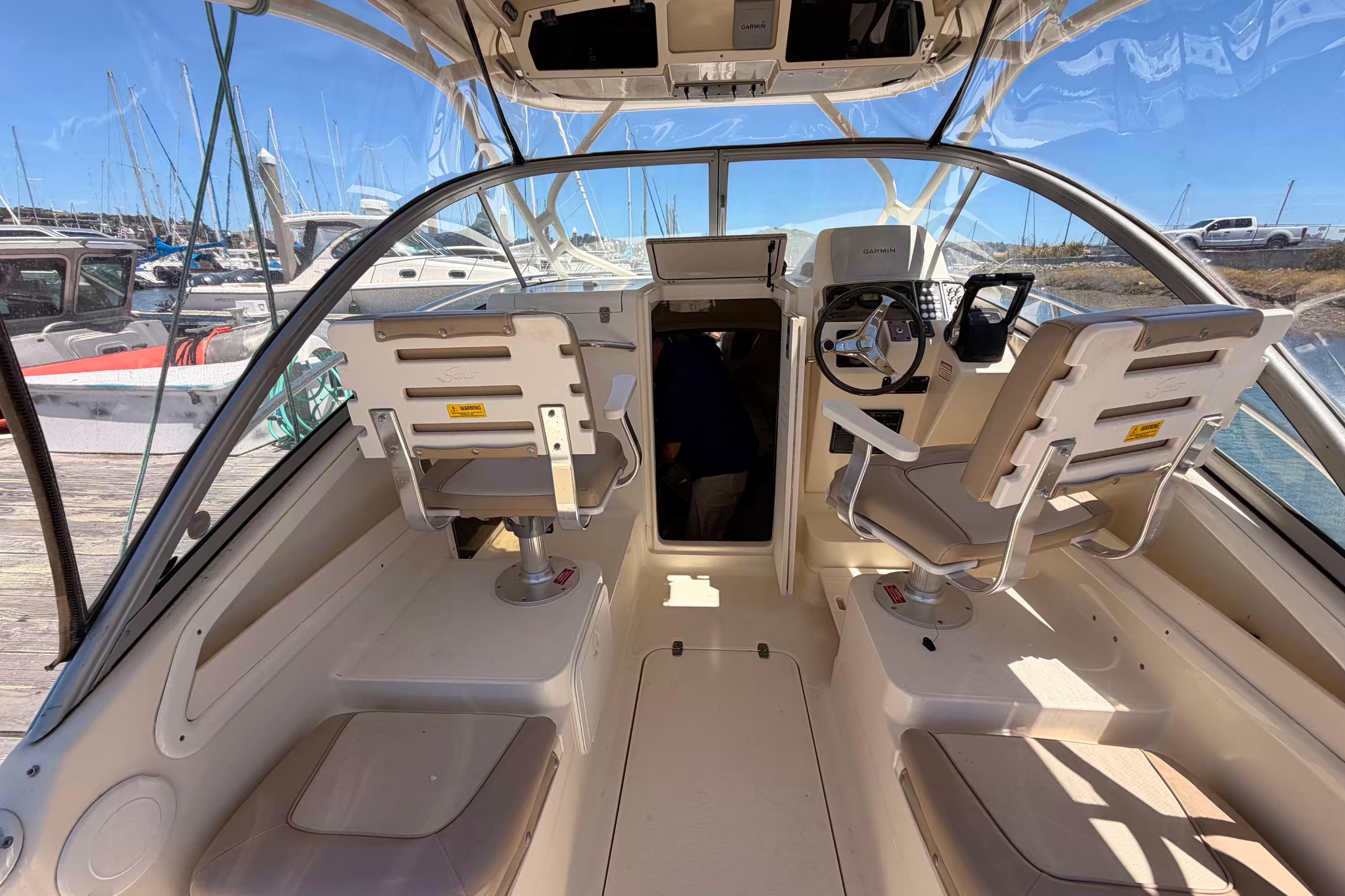 Interior view of 2007 Scout 262 Abaco boat cockpit with steering wheel and seating.