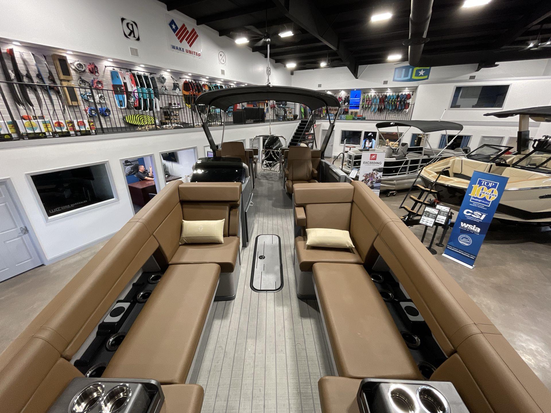 2025 Balise Horizon 26C boat interior in showroom with seating and accessories.