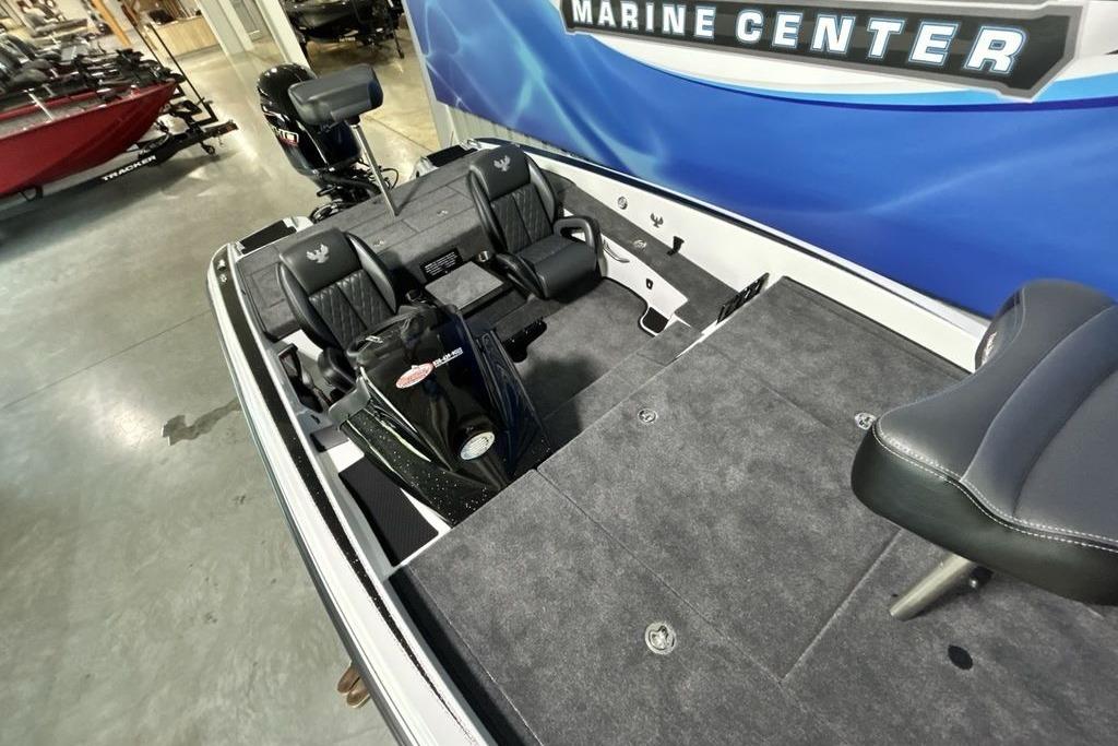2026 Phoenix 818 Pro boat interior with seating and motor at a marine center.