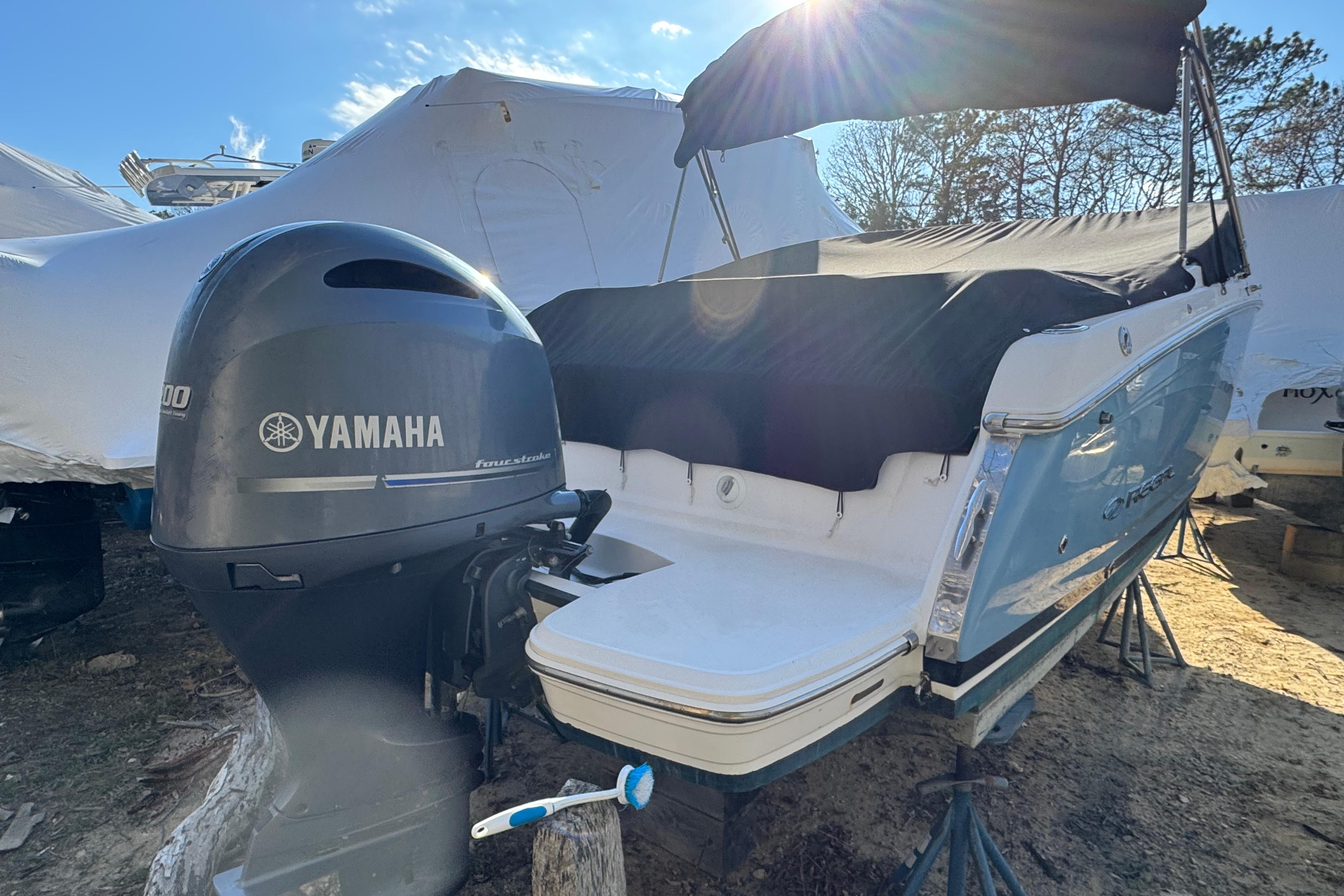 2017 Regal 23 OBX boat with Yamaha outboard motor, covered and stored outdoors.