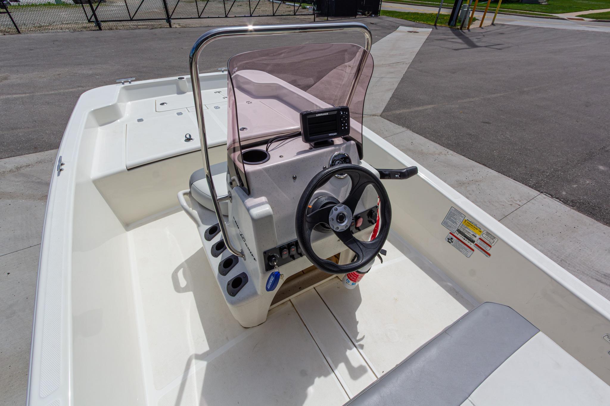 2020 Mako Pro Skiff 15 CC boat interior with steering wheel and console.