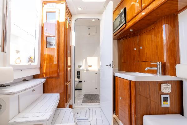 Luxurious interior of 2020 HCB 53 Sueños yacht with wooden cabinetry and modern amenities.