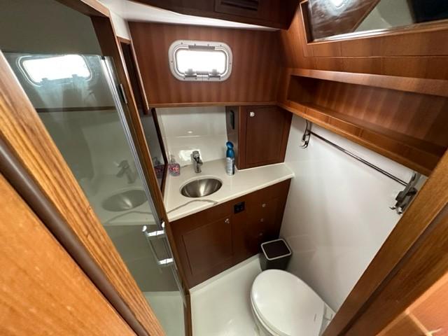 Modern bathroom in 2025 Bracewell 41 yacht with wood accents and compact design.