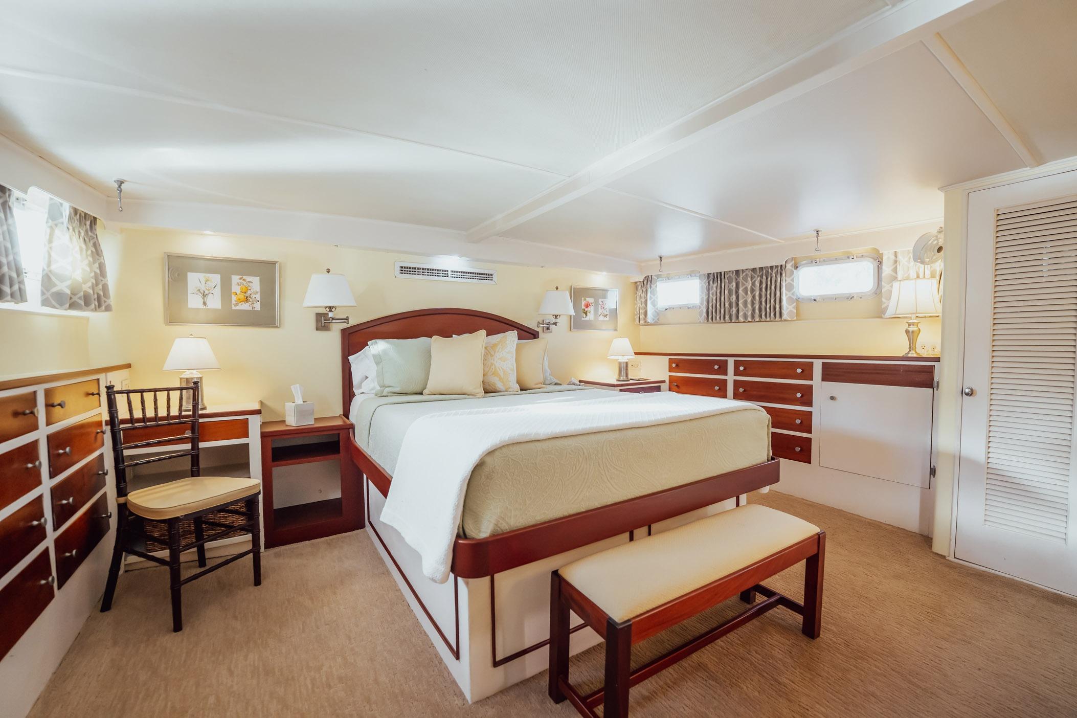 Luxurious bedroom interior of 1972 Trumpy 72 Motor Yacht with elegant furnishings and soft lighting.