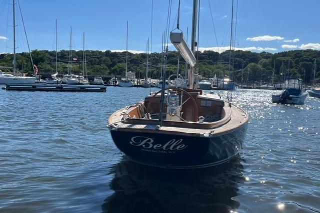 Sailboat "Belle" on water, Morris 36, 2006 model, sunny day, marina background.