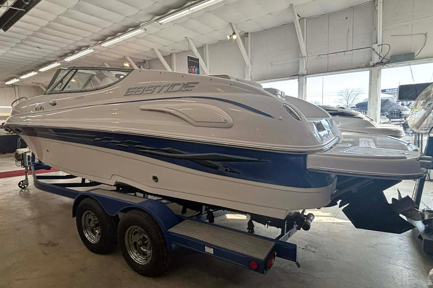 1999 Tide Craft Trophy Angler boat on trailer in indoor showroom.