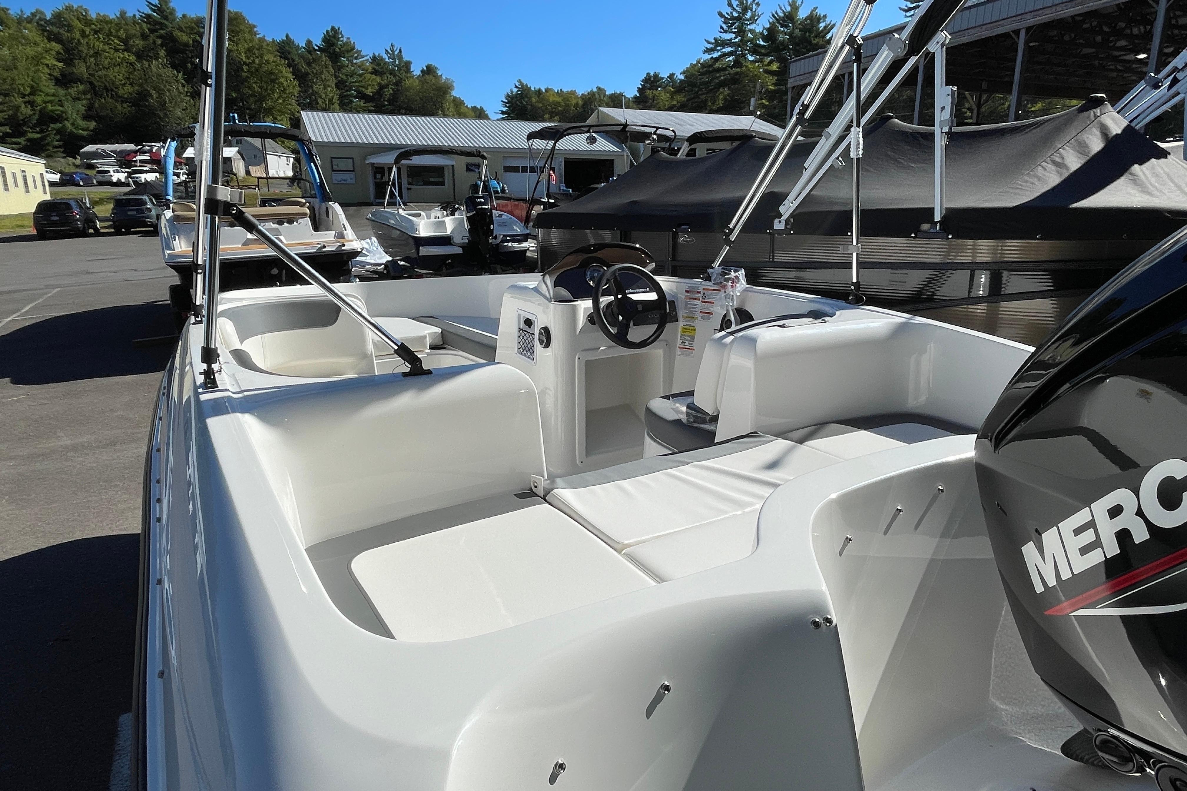 2026 Bayliner Element E16 boat with Mercury engine, parked outdoors.