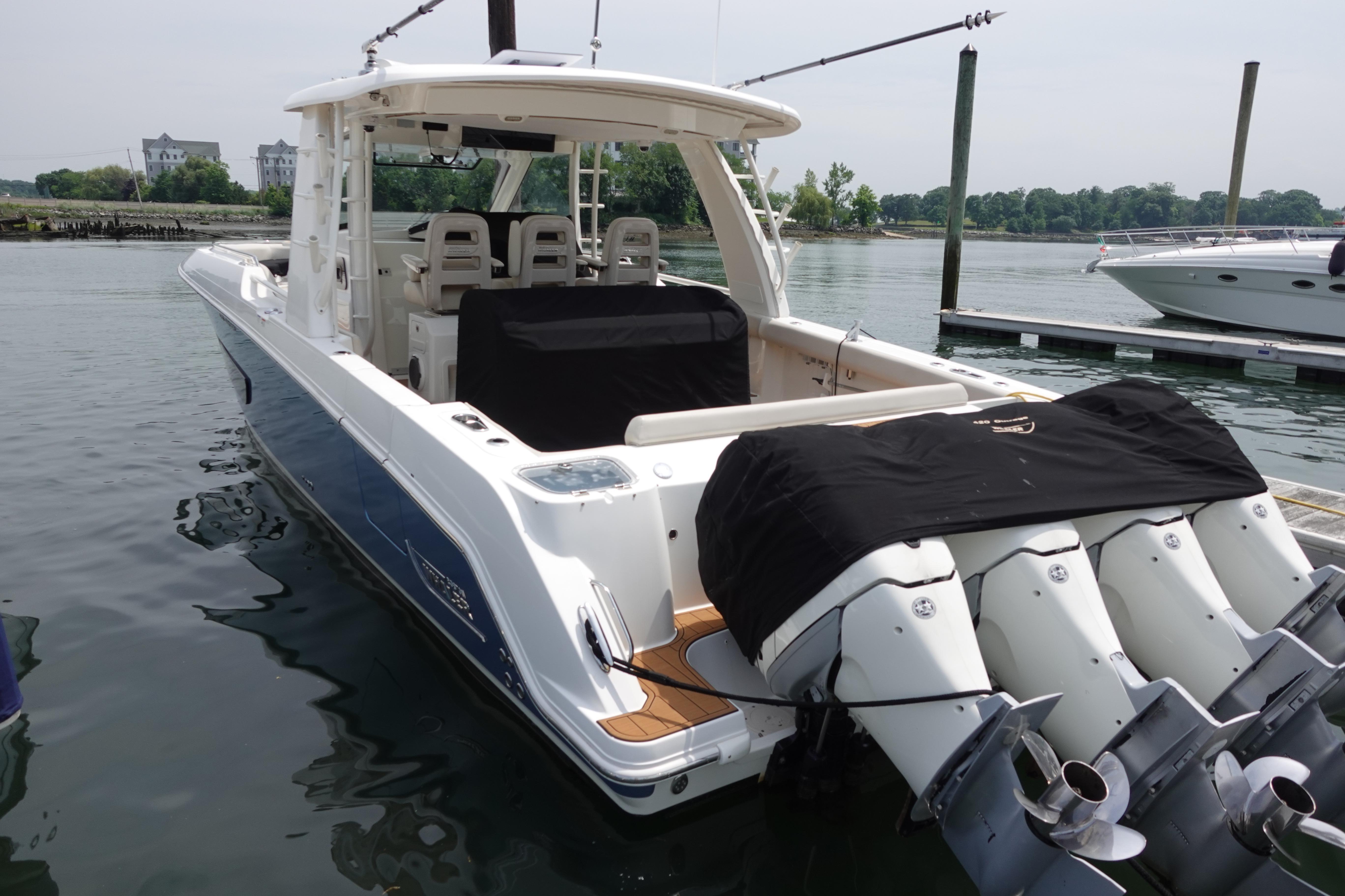 2020 Boston Whaler 420 Outrage docked, featuring powerful outboard engines and sleek design.