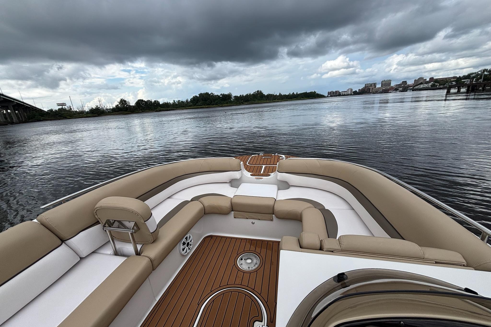 2017 Starcraft Star Step 221 I/O boat interior with tan seating on a calm river.